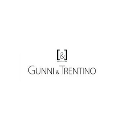 Logotipo de Gunni & Trentino en blanco sobre fondo negro